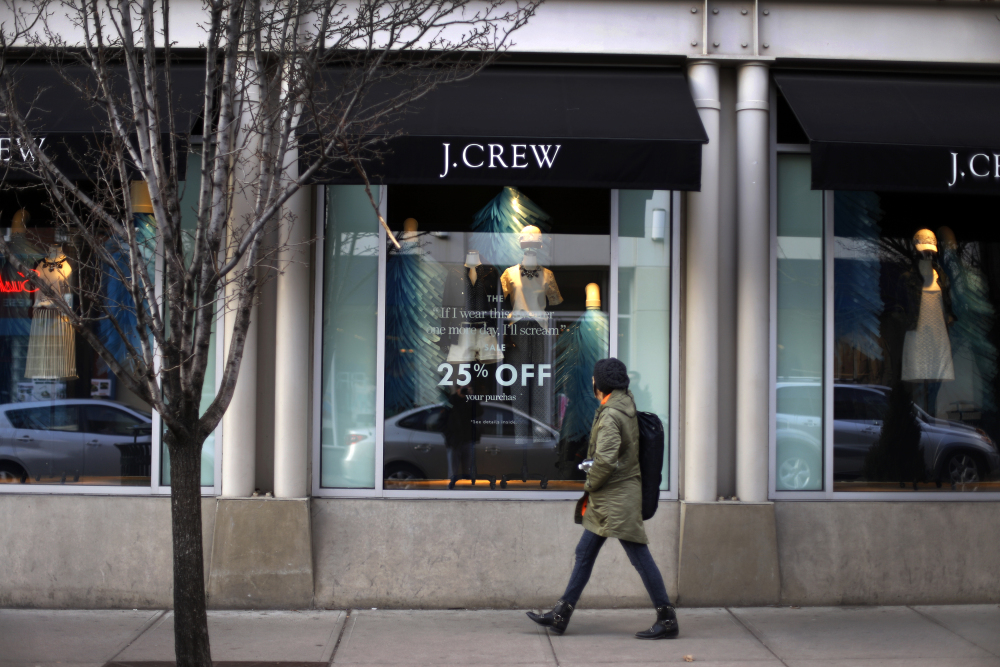 In this March 24, 2014 photo, a pedestrian passes a J.Crew store in the Shadyside shopping district of Pittsburgh. The Commerce Department reports on retail sales for March on Monday, April 14, 2014.