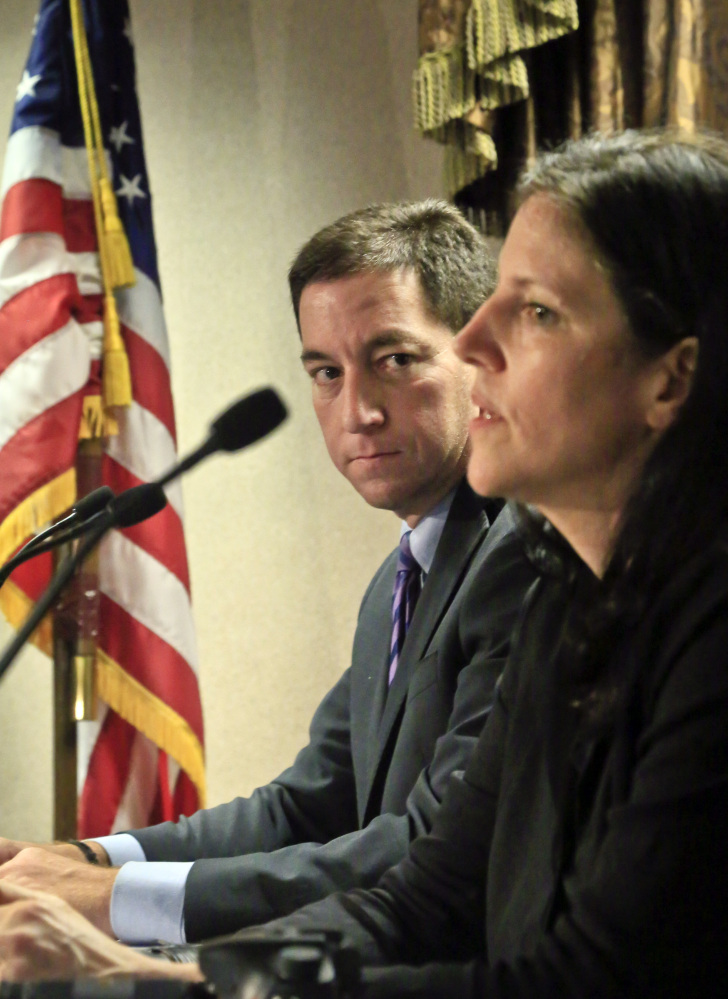 Journalist Glenn Greenwald, left, listens as Laura Poitras speaks earlier this month. The Washington Post and The Guardian won the Pulitzer Prize in public service Monday for revealing the U.S. government’s sweeping surveillance efforts in stories based on secret documents handed over by National Security Agency leaker Edward Snowden. The reports were published by Barton Gellman of The Post and Greenwald, Poitras and Ewan MacAskill of The Guardian.