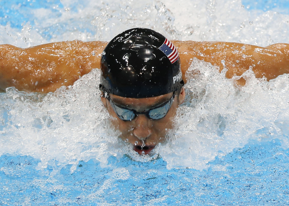 Michael Phelps swims in the men’s 4 X 100-meter medley relay at 2012 Summer Olympics in London, in this Aug. 4, 2012, photo.
