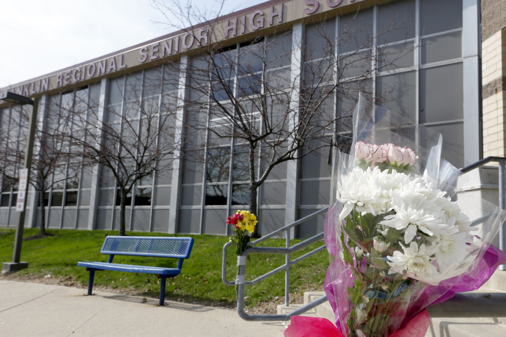 A bouquet of flowers is taped to a stairway rail near the closed entrance to Franklin Regional High School near Pittsburgh last week in Murrysville, Pa.
