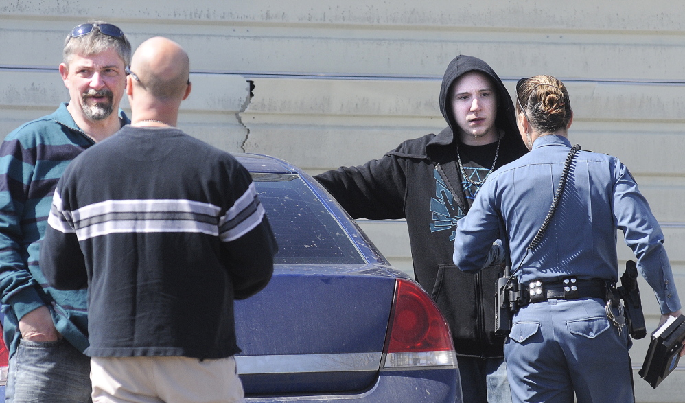 Fred Horne Sr., left, and Fred Horne Jr. speak with State Police officers on Thursday after being charged with sex trafficking at their Sidney residence. The two were evicted from a North Belgrade house last June when the landlord suspected similar activity, according to affidavits on the case released Tuesday.