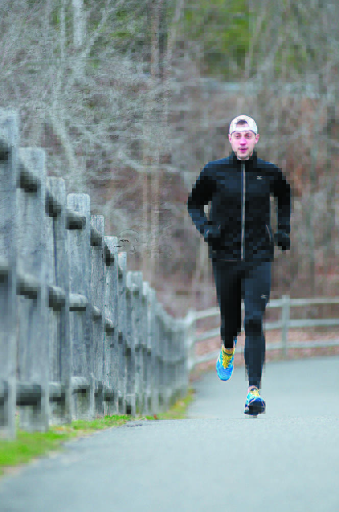 BEFORE THE BOMBINGS: Seth Hasty runs on the Kennebec River Rail Trail in Gardiner last year, three days before he ran in the Boston Marathon. Hasty had finished the race and was at dinner when the bombs went off last year. He is running again this year. On the anniversary of the bombing Tuesday, he said that after last year, “I couldn’t wait to sign up.”