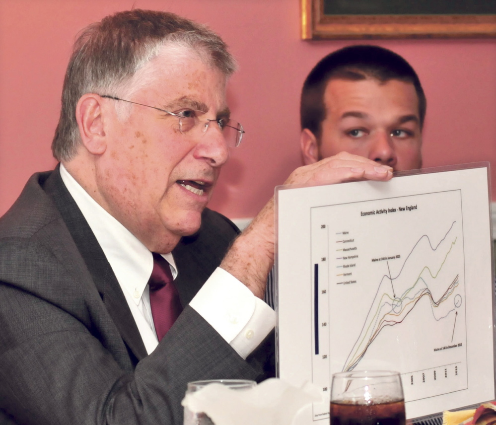 ECONOMY: Independent gubernatorial candidate Eliot Cutler displays a graph that illustrates Maine’s lack of economic growth during a campaign stop Tuesday in Skowhegan. At right is Skowhegan Rotary Club member Reid Gibson.