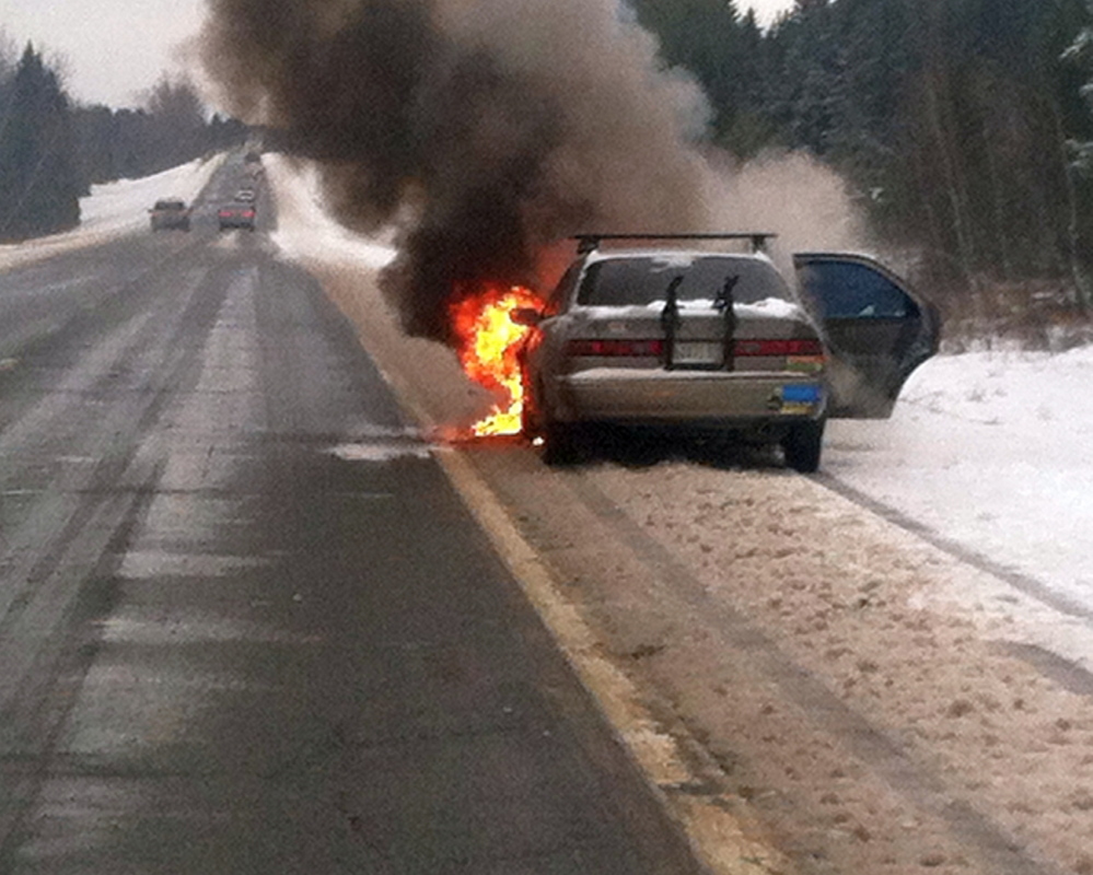 car fire: A car burns Wednesday morning on Interstate 95 in Pittsfield. Godefroy Watchiba of Portland told police he heard a loud noise under the 1999 Toyota Camry and pulled over to investigate, when it burst into flames.