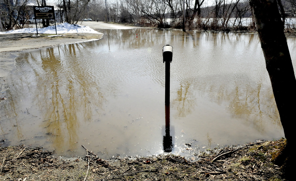 NO MAIL: A mailbox and post are surrounded by water from the Kennebec River that overflowed on Lithgow Street in Winslow, forcing officials to close the road Wednesday. The road closure is near where seven homes were washed down river during a flood in 1987.