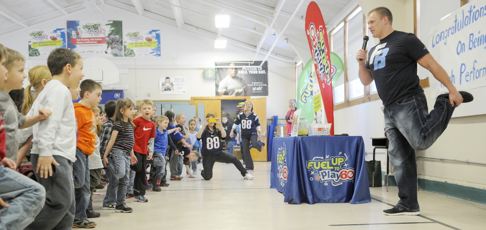 AN EXERCISE IN MOBILITY: National Football League player Matt Mulligan shows Pittston Consolidated School students a stretch Wednesday during a visit. His visit was a reward for the school’s participation in Fuel Up to Play 60, the NFL’s nutrition and fitness initiative.