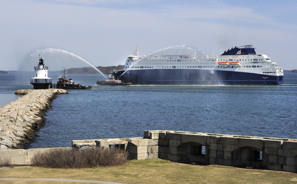 The 530-foot-long Nova Star ferry receives sprays of welcome as it passes Spring Point Light in South Portland on its way to Portland Harbor.