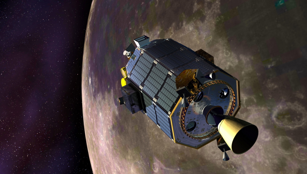 In this artist’s concept provided by NASA the Lunar Atmosphere and Dust Environment Explorer – LADEE – spacecraft is seen orbiting the moon .