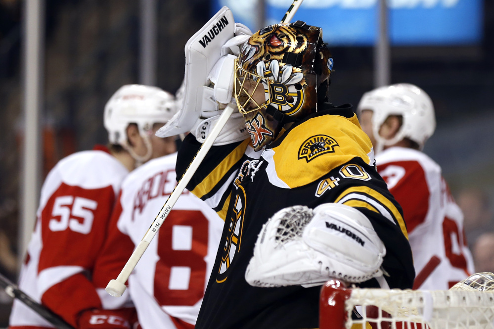 Boston Bruins goalie Tuukka Rask grimaces as Detroit Red Wings celebrate Pavel Datsyuk’s goal during the third period of Detroit’s 1-0 win in Game 1 of a first-round NHL playoff hockey game in Boston on Friday, April 18, 2014.