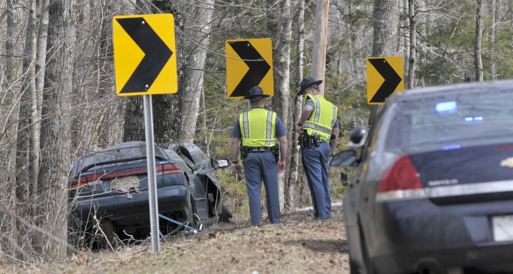 Fatal: Maine State Police troopers stand next the wreckage of a fatal car accident on Stone Road in Vassalboro on Friday.