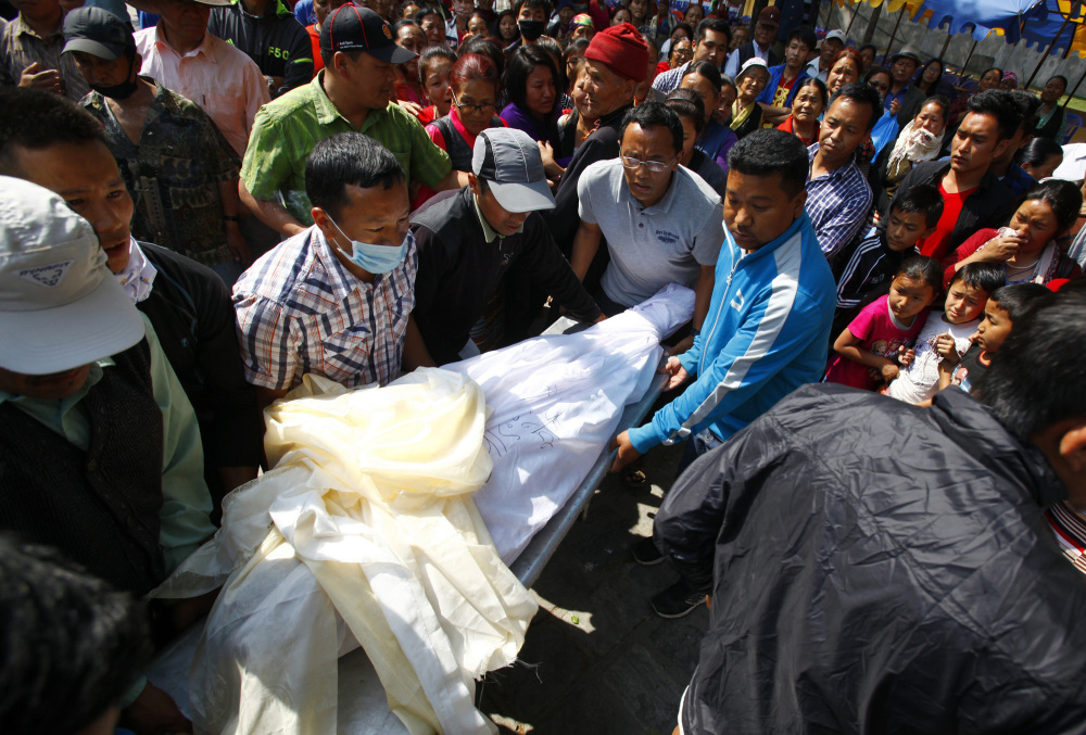 The body of Nepalese mountaineer Ang Kaji Sherpa, killed in an avalanche on Mount Everest, is carried to the Sherpa Monastery in Katmandu, Nepal, Saturday.