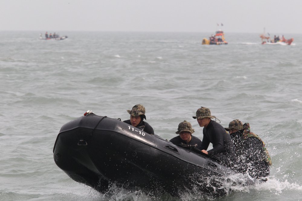 Members of the South Korean special forces set out to rescue passengers believed to have been trapped in the sunken ferry Sewol near the buoys that were installed to mark the vessel in the water off the southern coast near Jindo, South Korea, on Monday.