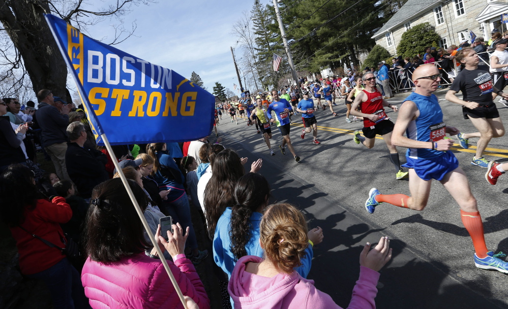Fans cheer runners as they start the 118th Boston Marathon on Monday in Hopkinton, Mass.