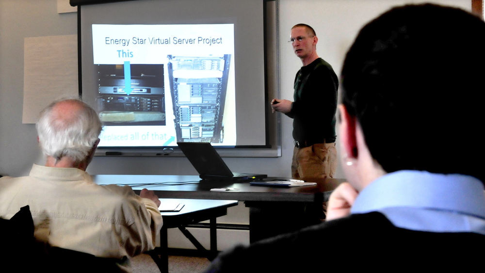 EFFICIENCY: Tim Downing, president of Duratherm Window Corp., speaks to business owners and municipal officials during an Earth Day Mid-Maine Climate Adaptation presentation on energy efficiency at Kennebec Valley Council of Governments on Tuesday.