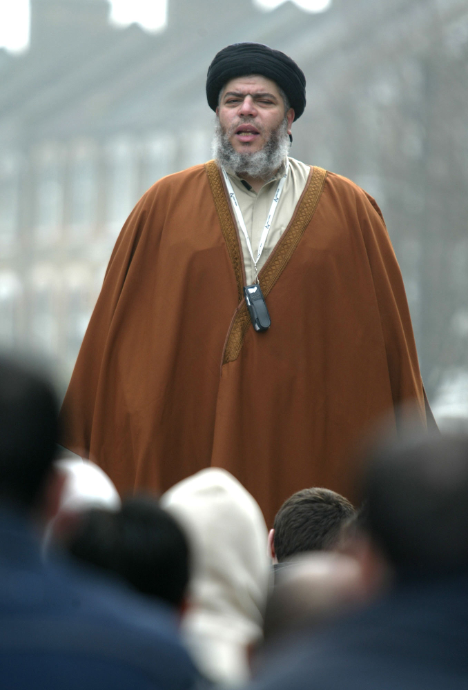 Radical Muslim cleric Mustafa Kamel Mustafa prays in a street outside his Mosque in north London in this 2003 photo. Mustafa faces charges he conspired to support al-Qaida by trying in 1999 to set up a terrorist training camp in Bly, Ore., and by helping abduct two American tourists and 14 others in Yemen in 1998.