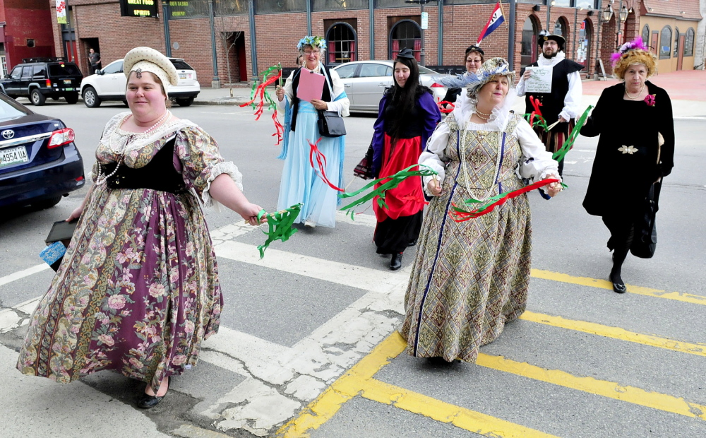 HAPPY BIRTHDAY: Dressed in period outfits a group from the Recycled Shakespeare company crosses Main Street in Waterville during a celebration Shakespeare’s 450th birthday. Leading the group is Emily Fournier, left, and her mother, Lyn Rowden.