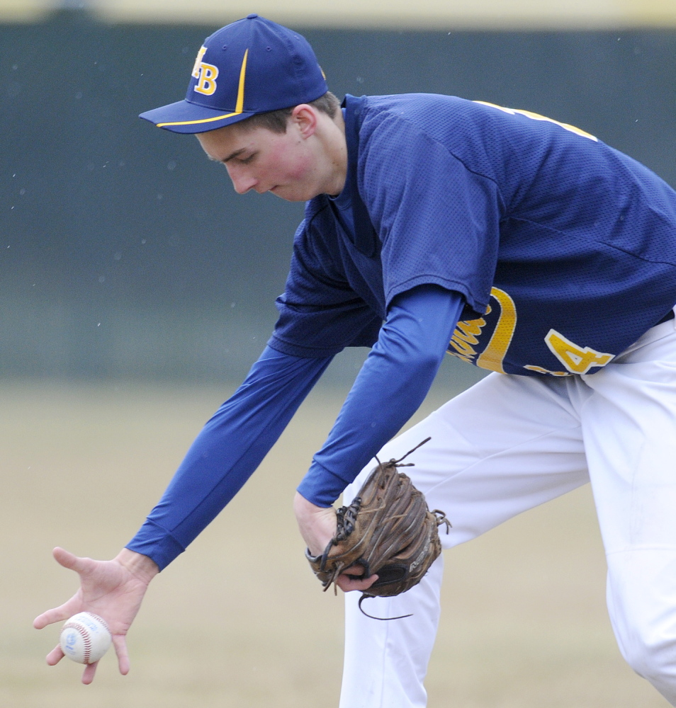 Staff photo by Andy Molloy Mt. Blue's Amos Herrin collects a grounder with his throwing arm Wednesday at short stop during a baseball match up against Cony in Augusta.