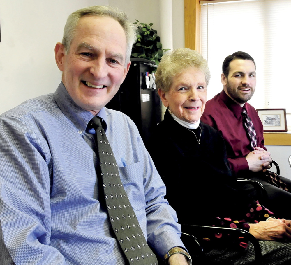 TOP BUSINESS: Tom McAdam, left, Carol Welch and Bruce Harrington of Kennebec Behavior Health speak about the organization being named Business of the Year by the Mid-Maine Chamber of Commerce.