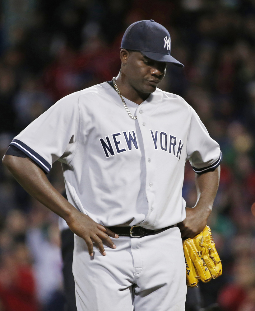 Yankees pitcher Michael Pineda walks off the mound after being ejected when pine tar was discovered on his neck Wednesday at Fenway.
