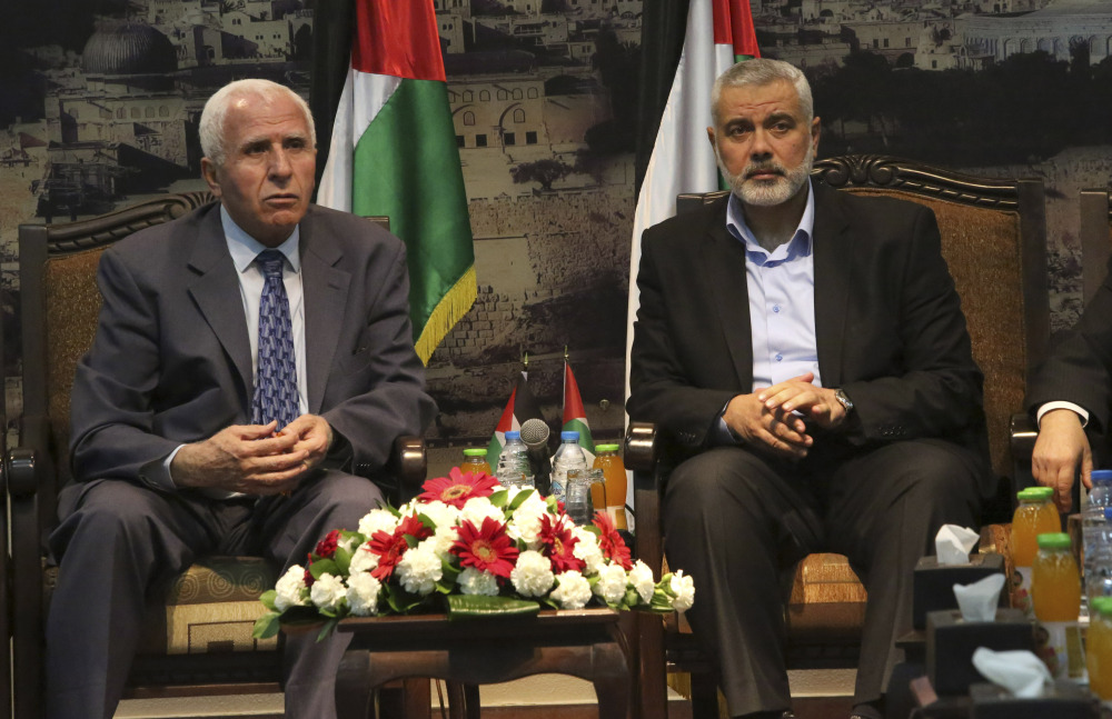 Gaza’s Hamas Prime Minister Ismail Haniyeh, right, and senior Fatah official Azzam al-Ahmad meet in Gaza for talks aimed at reaching a reconciliation agreement between the two rival Palestinian groups, Hamas and Fatah on Tuesday.