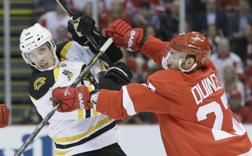 Detroit defenseman Kyle Quincey checks Boston right wing Reilly Smith in the first period Thursday.
