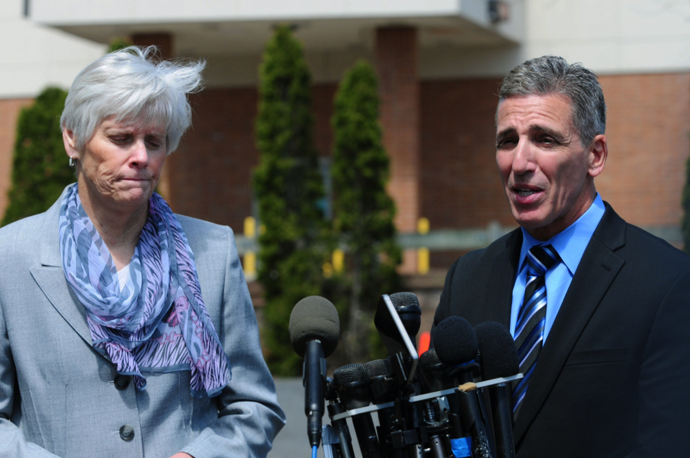 Milford Police Chief Keith Mello, right, speaks while Schools Superintendent Elizabeth Feser listens during a news conference at Jonathan Law High School in Milford, Conn., Friday.