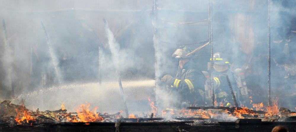 FIRE SCENE: Firefighters battle a mobile home fire at 651 Winslow Road in Albion on Friday.