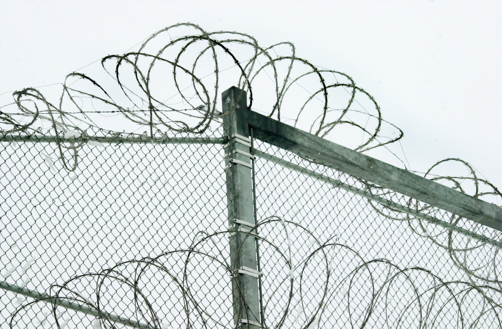 prison security: Razor wire is coiled along the top of the security fence at the Maine State Prison in Warren. State officials have made substantial improvements to policies on the use of segregation to punish disruptive inmates.