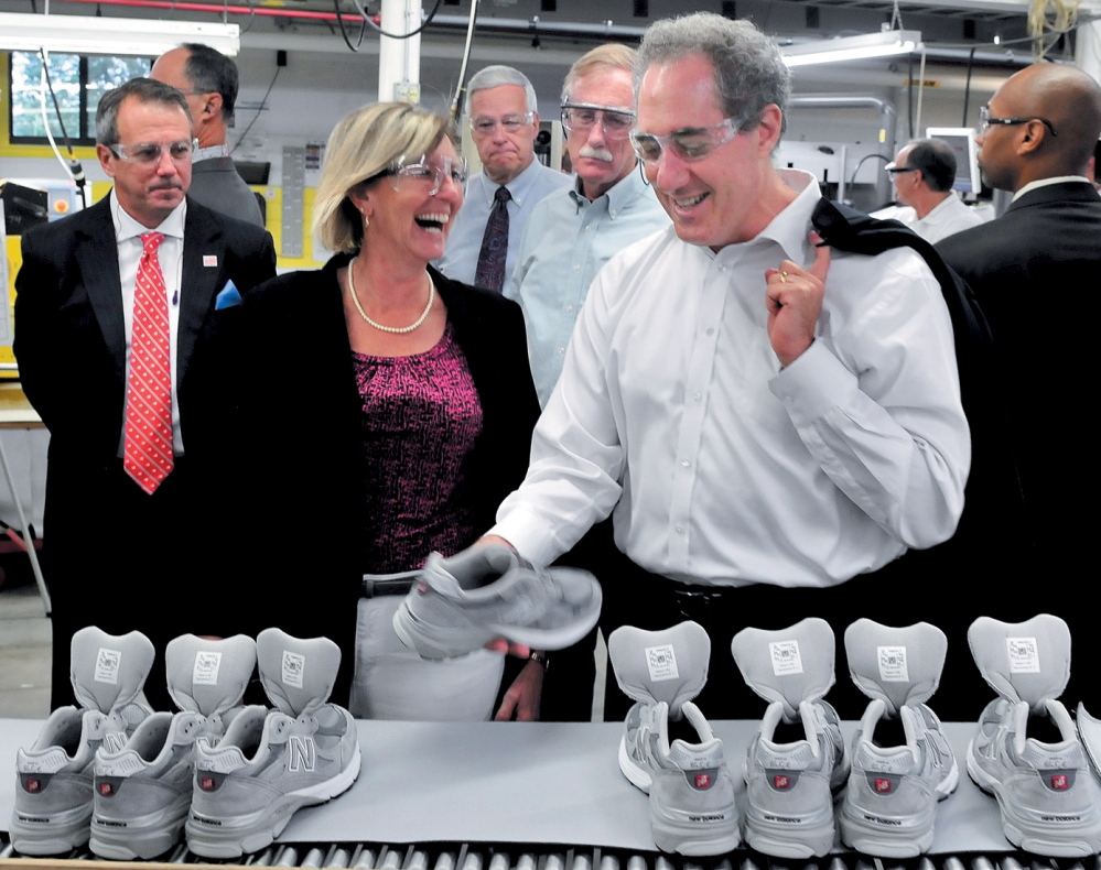 NICE FIT: U.S. Trade Representative Michael Froman, right, examines a sneaker at the New Balance company in Norridgewock during a tour in July. Company CEO Rob DeMartini, left, plant manager Raye Wentworth, U.S. Rep. Mike Michaud and U.S. Sen. Angus King Jr. also went on the tour.