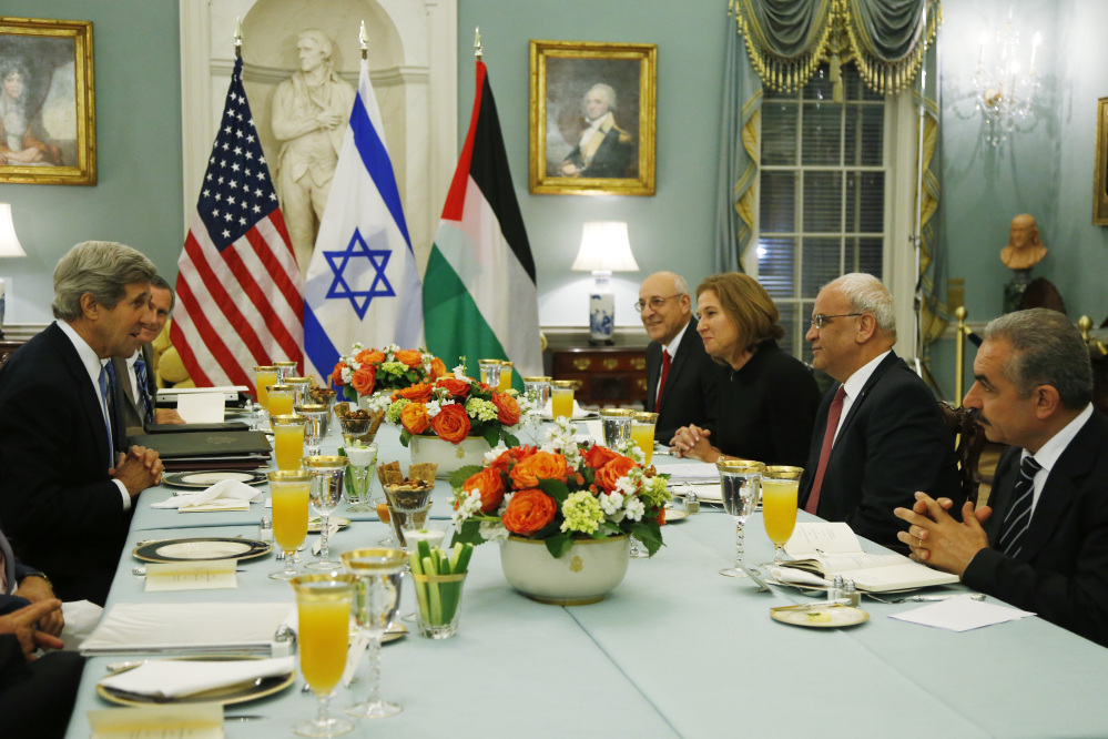U.S. Secretary of State John Kerry, left, sits across from Israel’s Justice Minister and chief negotiator Tzipi Livni, third right, Palestinian chief negotiator Saeb Erekat, second right, Yitzhak Molcho, an adviser to Israeli Prime Minister Benjamin Netanyahu, fourth right, and Mohammed Shtayyeh, aide to Palestinian President Mahmoud Abbas, right, at a dinner at the State Department in Washington that marked the resumption of Israeli-Palestinian peace talks last year. The talks are on the brink of collapse.