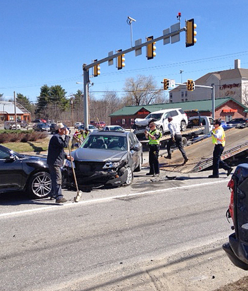 Crash: Police attend to a four-vehicle accident Friday on Kennedy Memorial Drive in Waterville.
