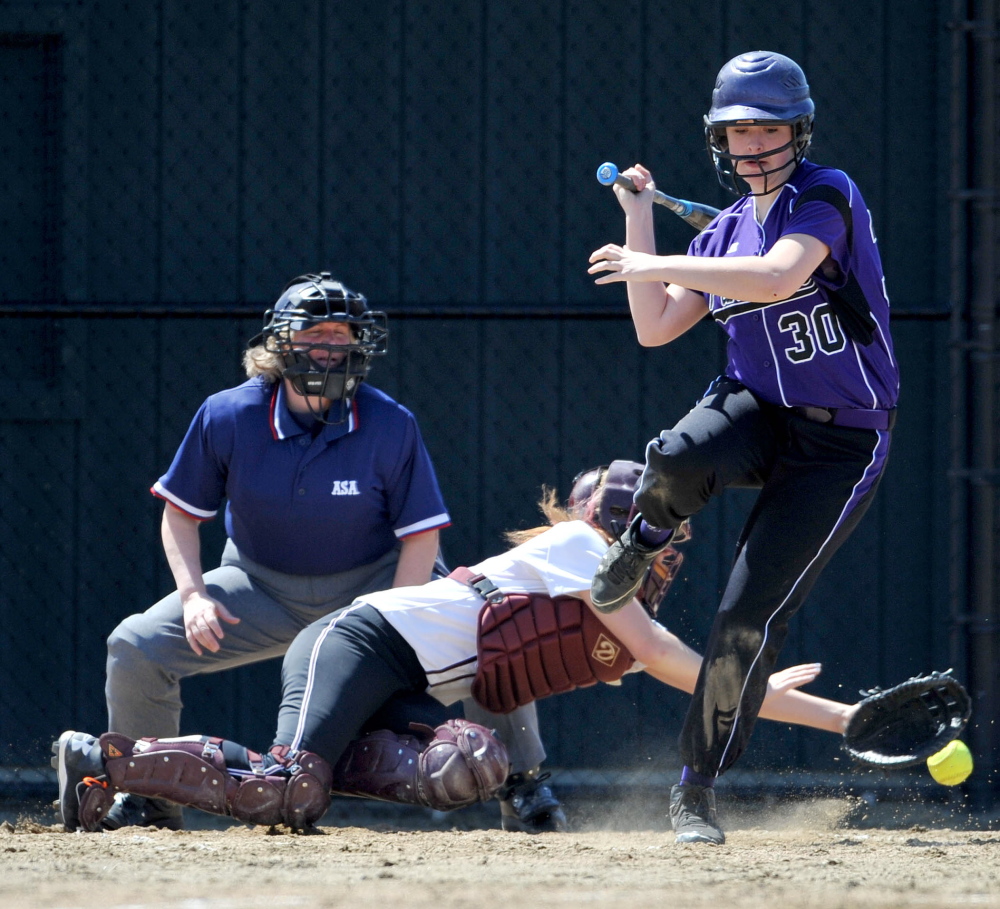 Staff photo by Michael G. Seamans Waterville Senior High School's Hannah Allen, 30, jumps out of the way from a pitch by Maine Central Institute's Jody Bickford, 21, in Waterville.