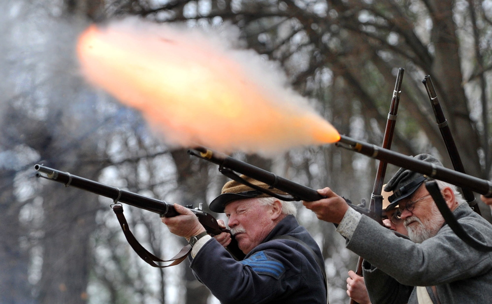 ALL FIRED UP: Members of the Confederate Army’s 15th Alabama Company perform a firing demonstration Saturday during a Civil War re-enactment at Abbott Park in Farmington.