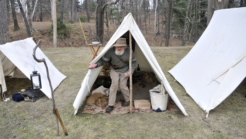 No plush accommodation: Tom Bassford, acting as a corporal with the Confederate Army’s 15th Alabama Company, emerges from his tent Saturday at a common Civil War camp at Abbott Park in Farmington.