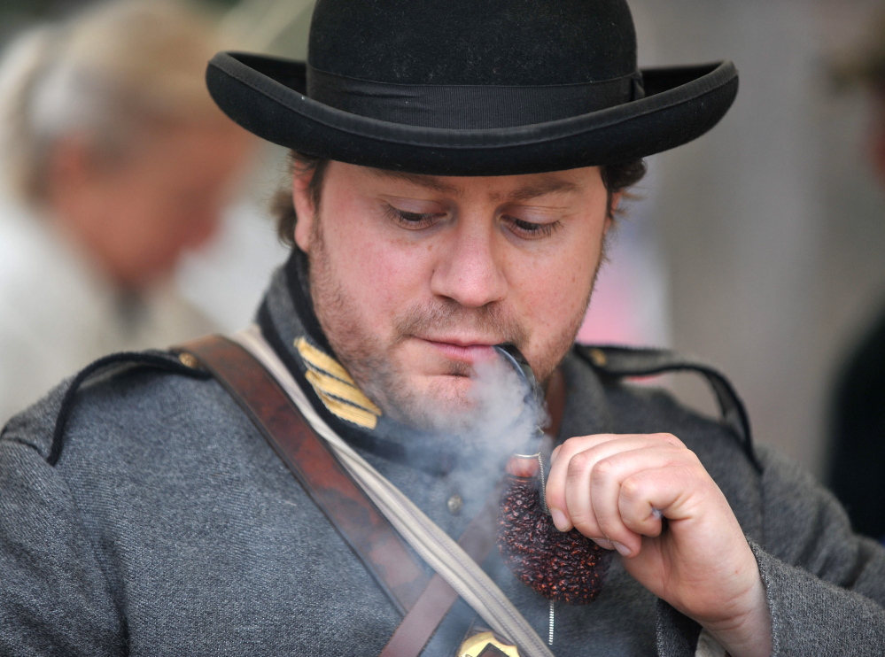 IN CHARACTER: Dave Laiche, captain of 15th Alabama Company, smokes a vintage pipe Saturday during a Civil War re-enactment at Abbott Park in Farmington.