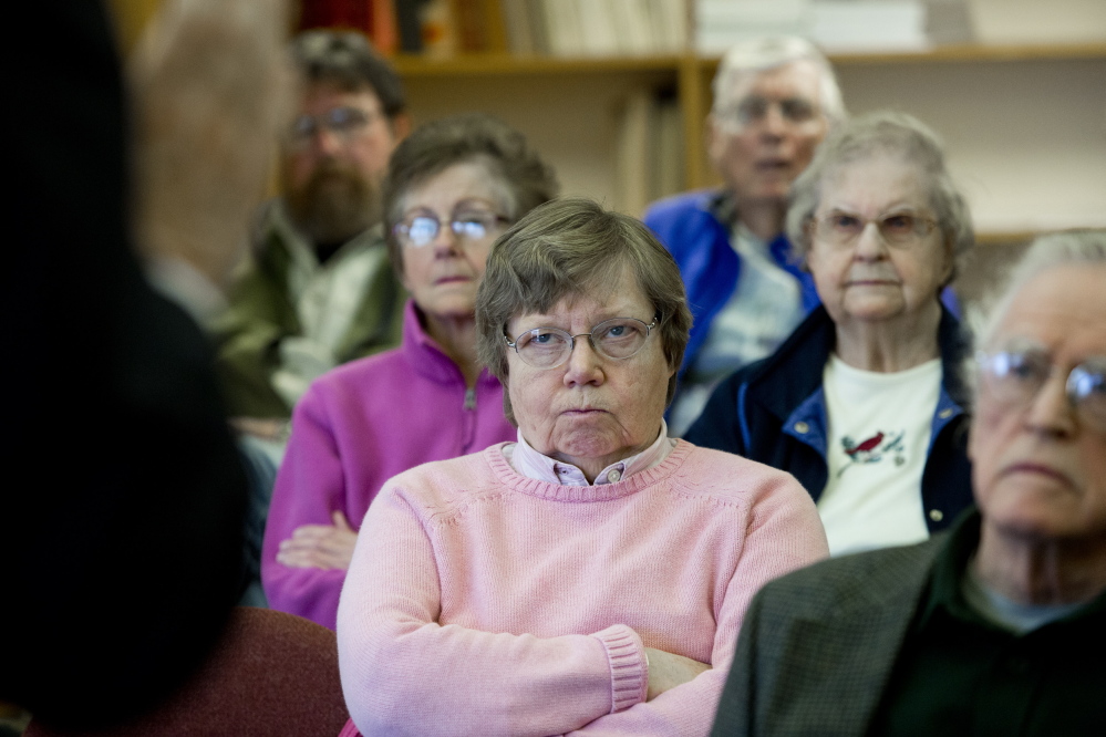 Sandra Barth of Boothbay, center, listens along with other seniors as Democratic gubernatorial candidate Mike Michaud talks about expanding Medicaid at a meeting at Boothbay Town Office on April 14. The issue of health care has emerged as source of sharp contrasts among the state’s Blaine House contenders.
