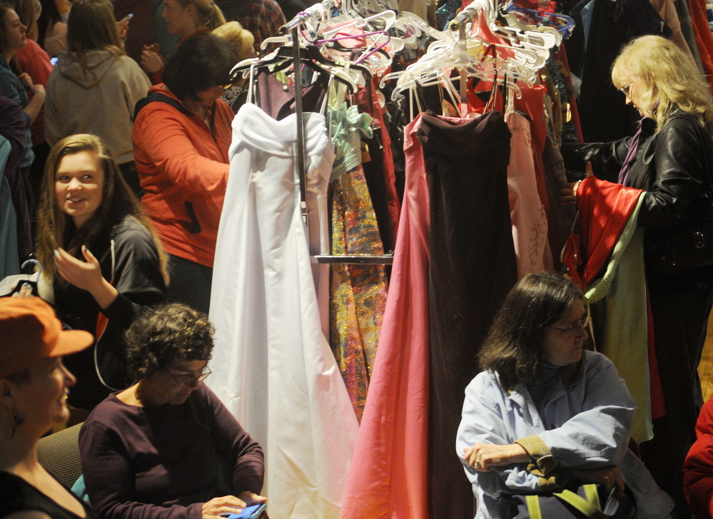 Dresses galore: People browse among prom dresses Saturday during the Cinderella Project at Johnson Hall in Gardiner. More than 100 teenage girls picked donated dresses, shoes and jewelry during the event.