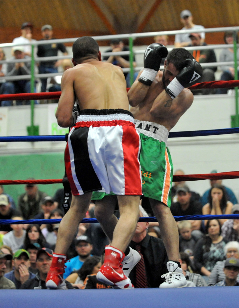 FIGHT NIGHT: Shane Tenney, green trunks, fights with Jorge Abiague in the first bout of the professional ranks at Wyman’s Boxing Club Boxing Show at Carrabec High School in North Anson on Saturday night.