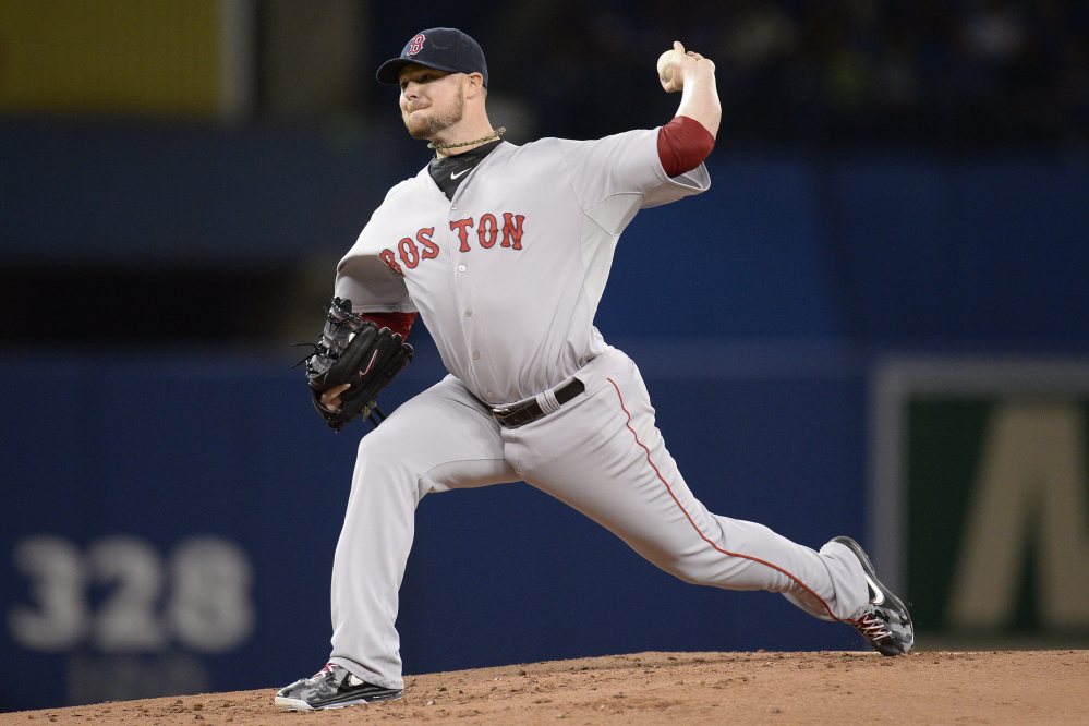 Red Sox starting pitcher Jon Lester delivers to the Toronto Blue Jays in the first inning in Toronto on Sunday.