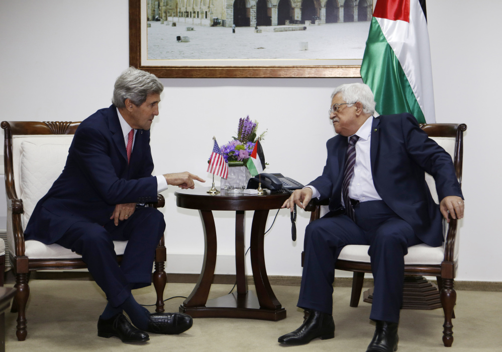 U.S. Secretary of State John Kerry meets with Palestinian President Mahmoud Abbas in the West Bank city of Ramallah in December.
