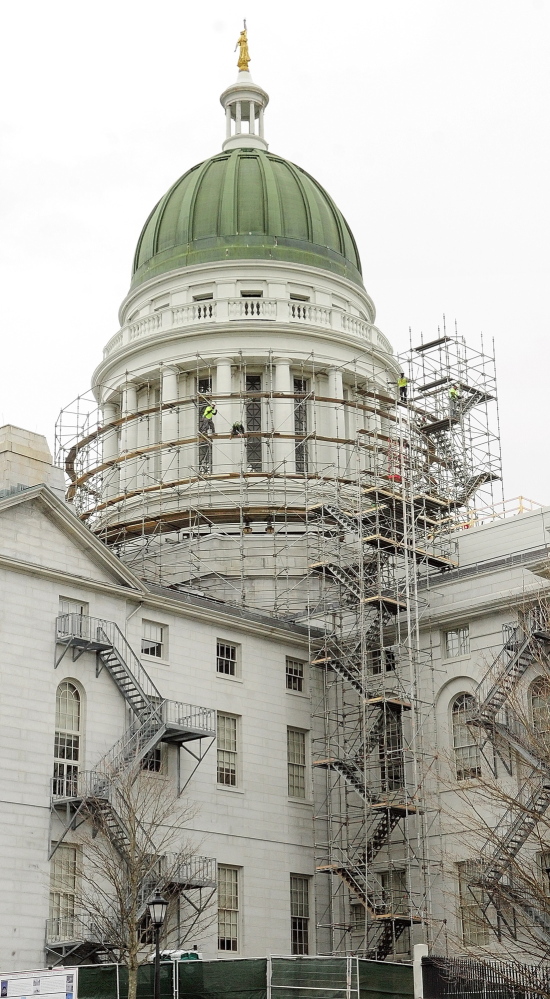 Rising Up: Workers build scaffolding around the State House dome on Wednesday in Augusta. This is the first part of a project to replace the old copper dome on the Capitol.