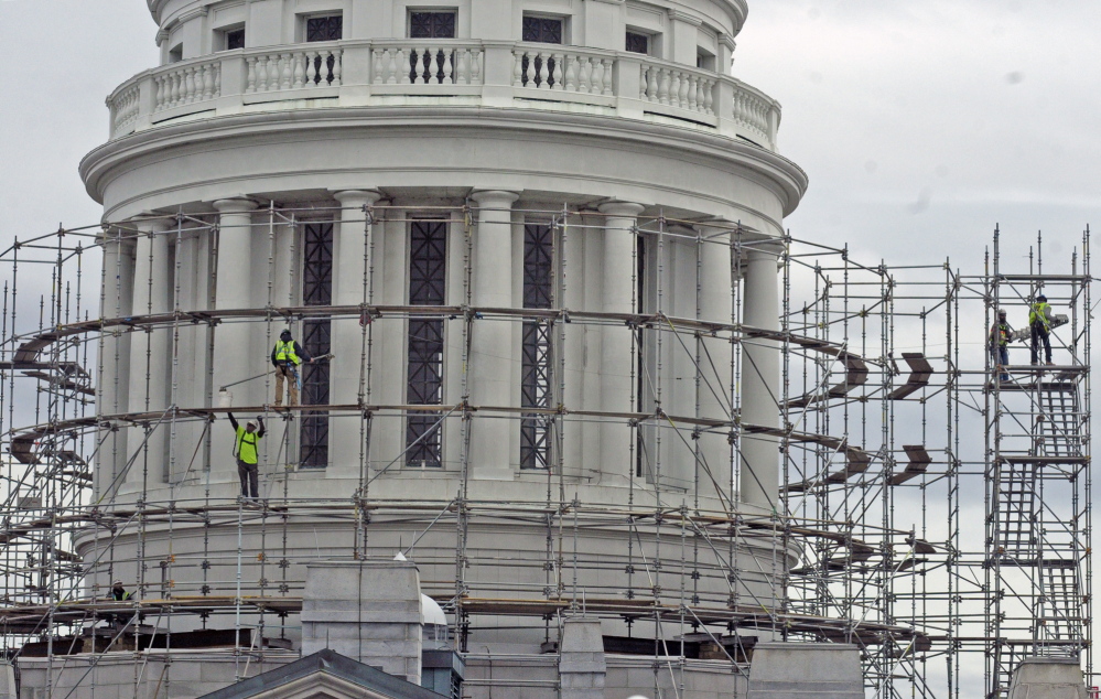 Prep: Workers build scaffolding around the State House dome on Wednesday in Augusta. This is the first part of a project to replace the old copper dome on the Capitol.
