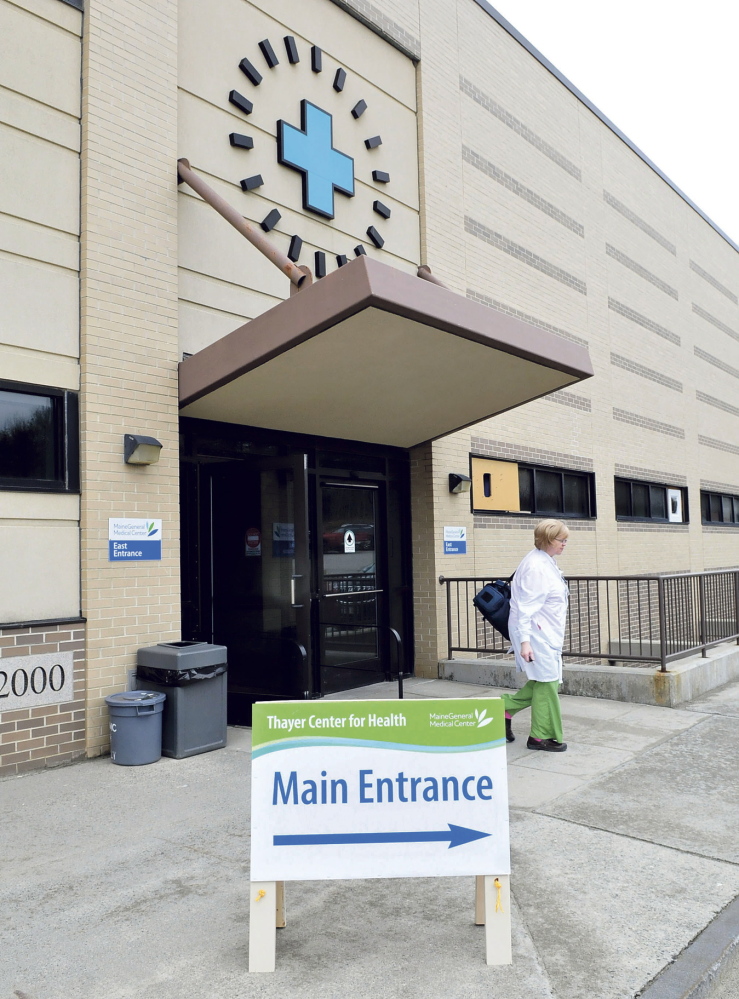 TEMPORARY: Thayer Center for Health employee Bonnie Dubois leaves the temporary entrance to the Waterville hospital on Monday. The entrance is at the rear and center of the hospital and should be used during the renovation project.