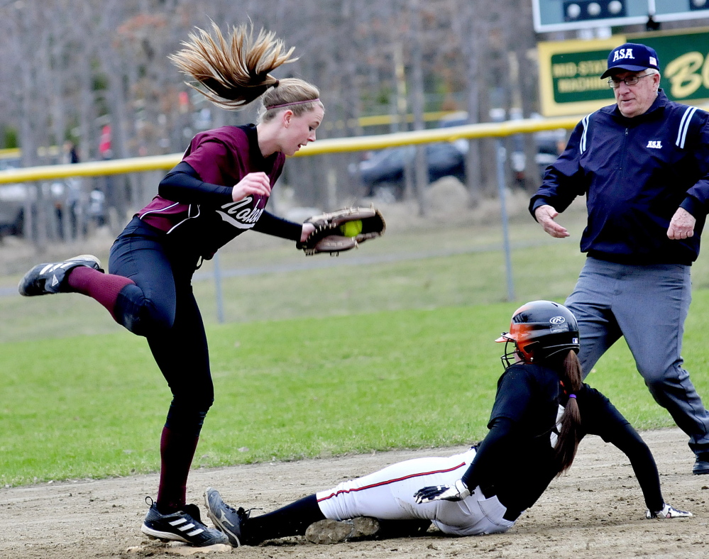 Staff photo by David Leaming Winslow’s Brooke Haskell slides safe into second base as Nokomis’ Becky Orcutt fields the throw in Winslow on Monday, April 28, 2014.