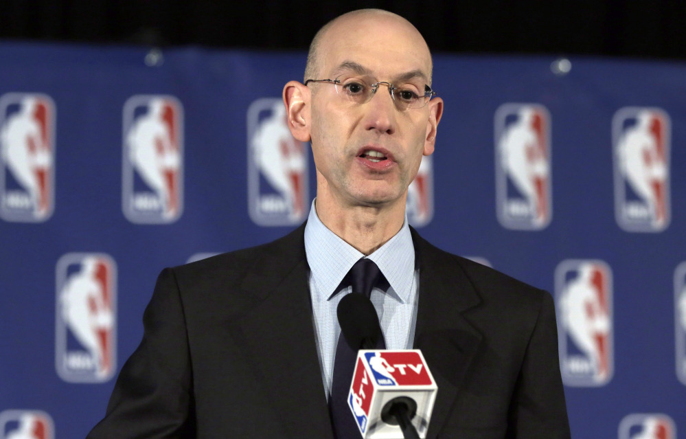 NBA Commissioner Adam Silver reads a statement during a news conference, in New York on Tuesday.