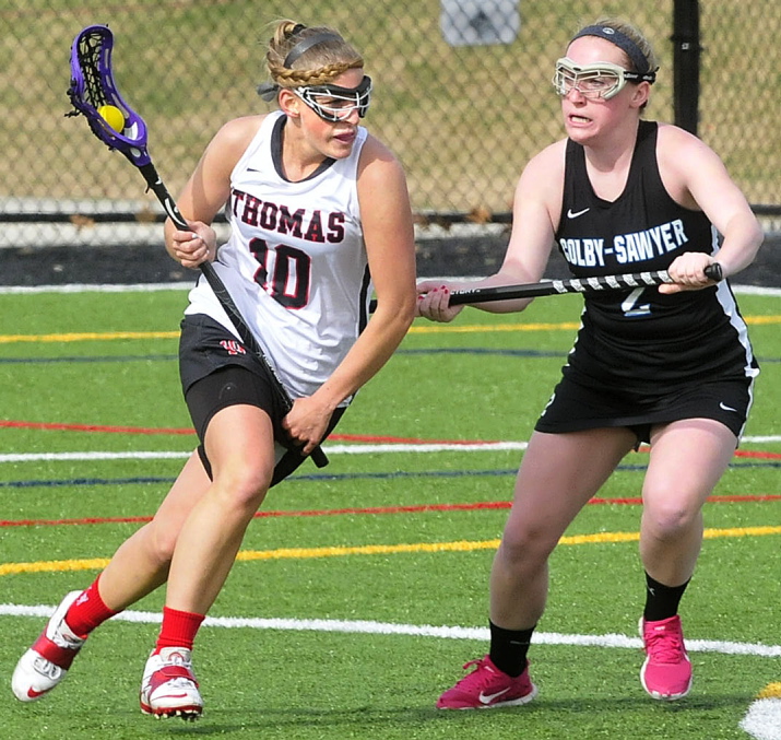 FINDING OPEN SPACE: Thomas College lacrosse player Jillian Lambert runs with ball past Colby-Sawyer player Paige Prokop on Tuesday in Waterville. Thomas won the game 18-2 and will play in the North Atlantic Conference championship game on Saturday.