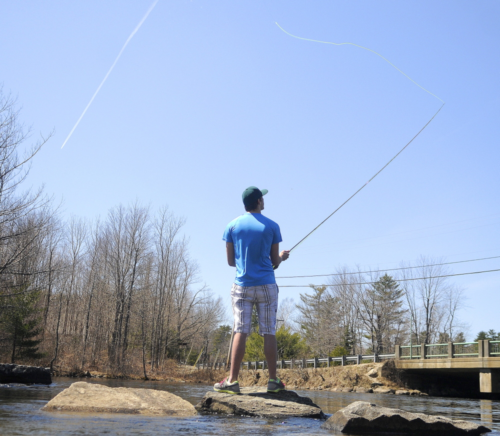 EARLY START: Michael Siddall casts a fly line for the first time April 20 on Cobbossee Lake in Manchester. Siddall, 18, of Winthrop, accompanied his father, Chris, on the outing. The lake didn’t officially have ice out until April 22.