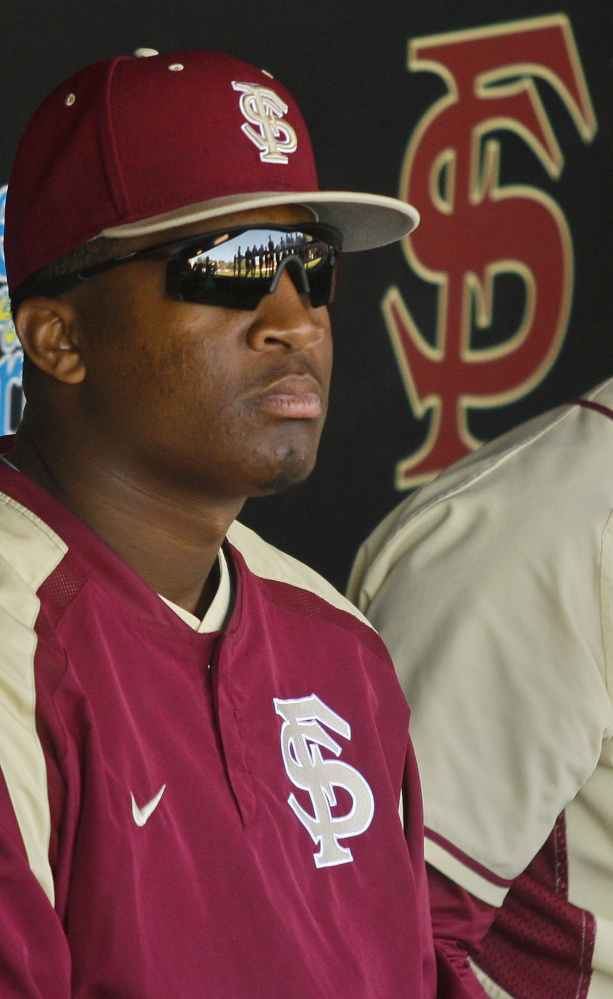In this March 2, 2014, file photo, Florida State relief pitcher Jameis Winston sits in the dugout in the sixth inning of an NCAA college†baseball†game against Miami in Tallahassee, Fla. The Florida State baseball team has indefinitely suspended Heisman Trophy winner Jameis Winston, who is a relief pitcher for the Seminoles. Baseball coach Mike Martin said in a statement Wednesday, April 30, 2014, that Winston was issued a citation the night before, but he did not give specifics. The Leon County Sheriff’s Office has declined comment.