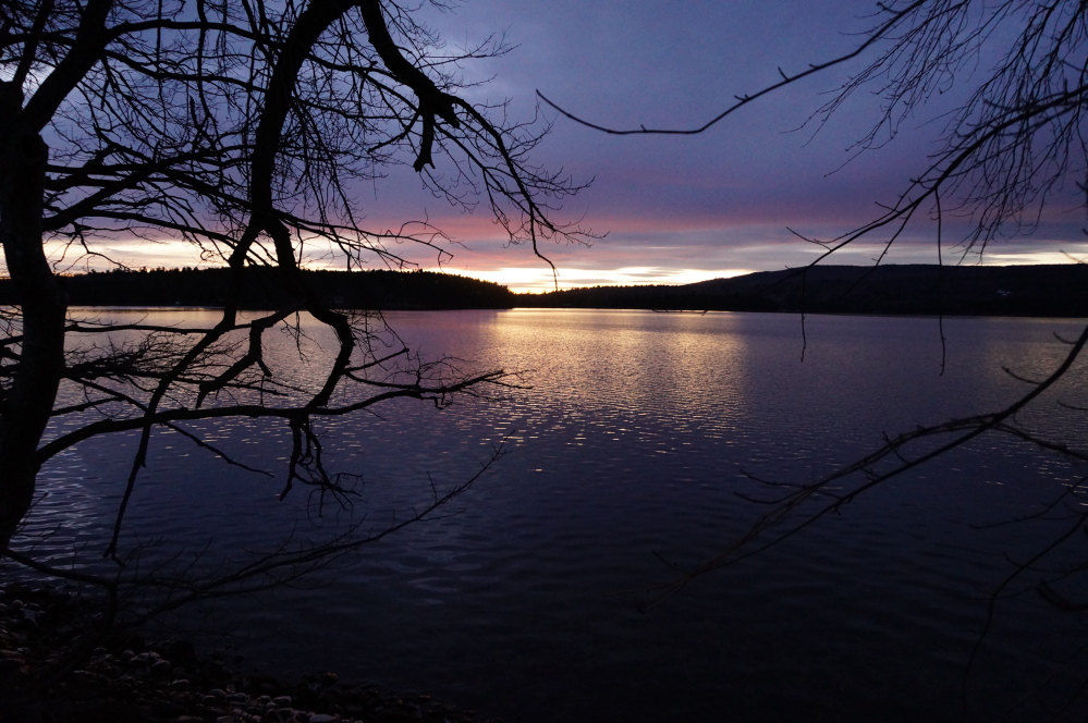 SILENTLY IMPAIRED: It’s hard to believe Long Pond — seen here at sunset from Belgrade Lakes village — is an impaired lake, but it’s deteriorating and local groups are talking about ways to stop the damage.