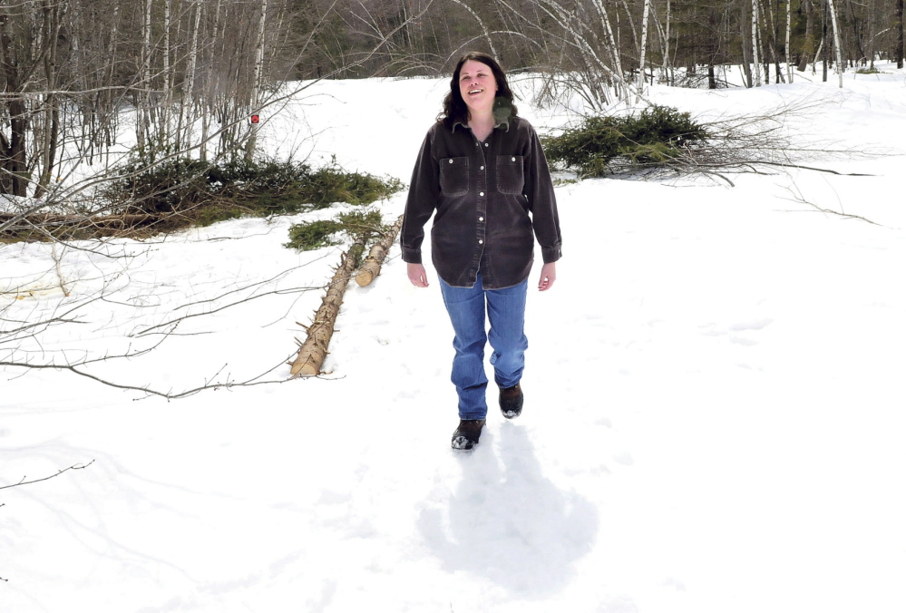GROWING: Samantha Burns, manager of the Madison Farmer’s Market, walks through a field cleared for vegetable gardens at her farm in Anson in early April.